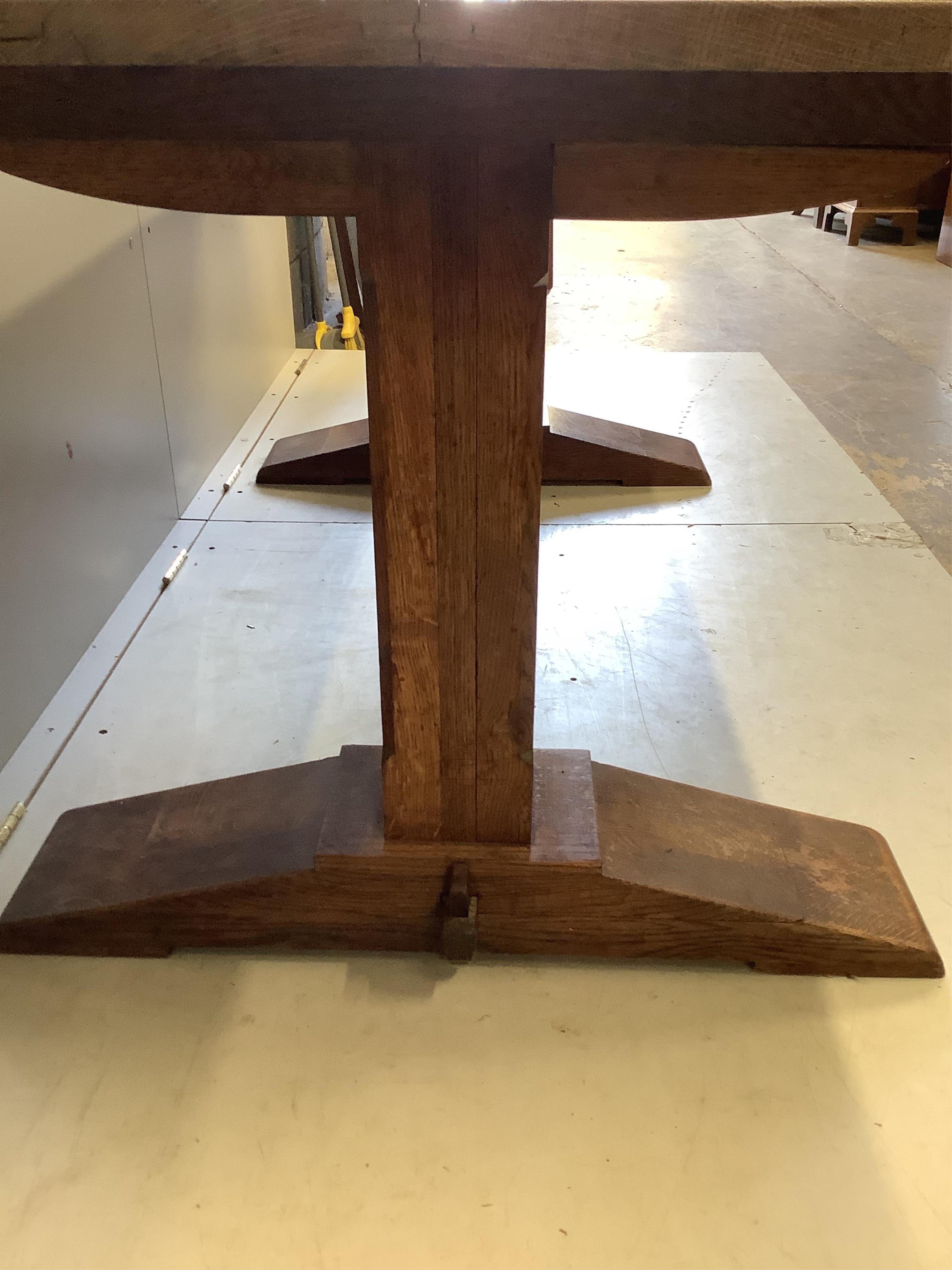 A 18th century style rectangular oak refectory dining table, width 183cm, depth 82cm, height 74cm and six rush seat ladderback chairs